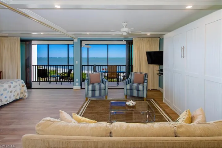 Living room with ceiling fan and wood-type flooring