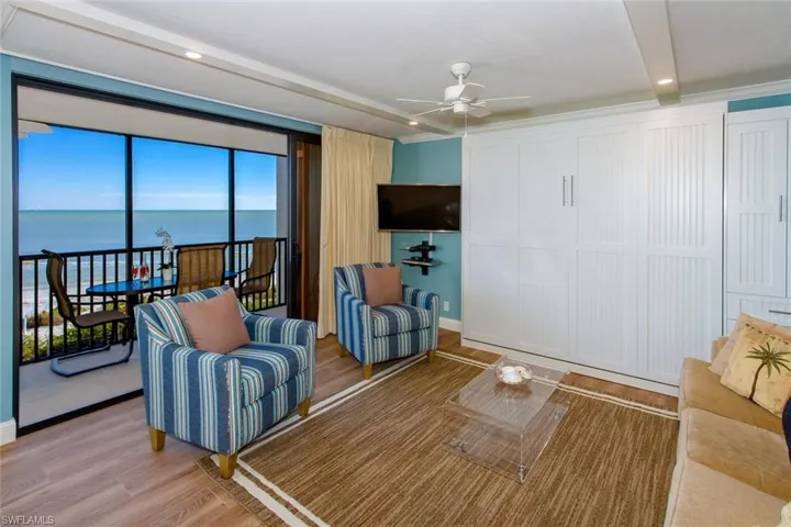 Living room featuring ceiling fan and wood-type flooring