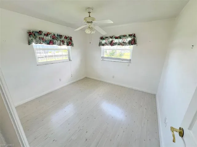 Unfurnished room featuring ceiling fan and light hardwood / wood-style flooring
