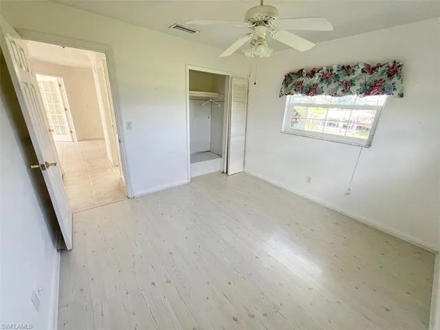 Unfurnished bedroom with ceiling fan, a closet, and light hardwood / wood-style floors