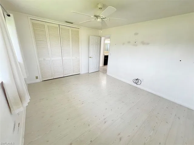 Unfurnished bedroom with a closet, ceiling fan, and light hardwood / wood-style flooring