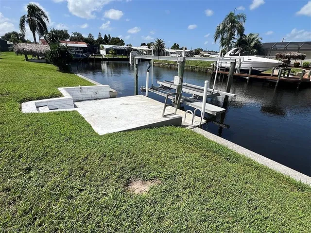 View of dock featuring a water view and a yard