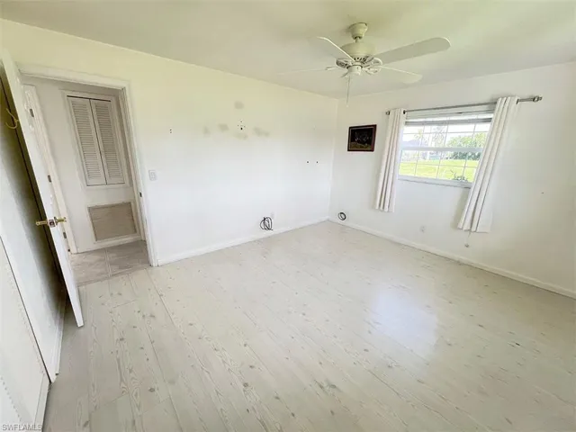 Empty room featuring light hardwood / wood-style flooring and ceiling fan
