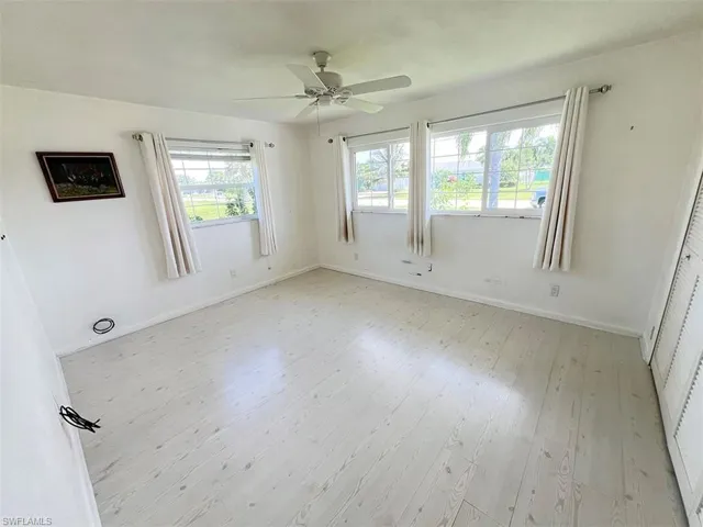 Unfurnished room with ceiling fan and light hardwood / wood-style floors