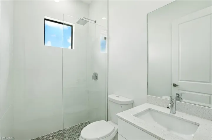 Bathroom featuring vanity and a shower stall