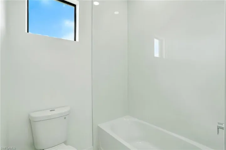 Bathroom with toilet and shower / washtub combination