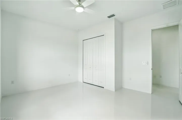 Unfurnished bedroom featuring a closet and a ceiling fan