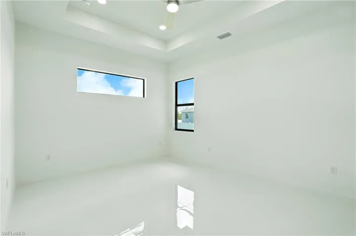 Empty room featuring recessed lighting and baseboards
