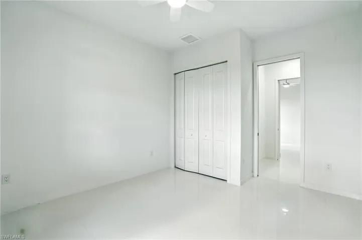 Unfurnished bedroom featuring a closet and a ceiling fan