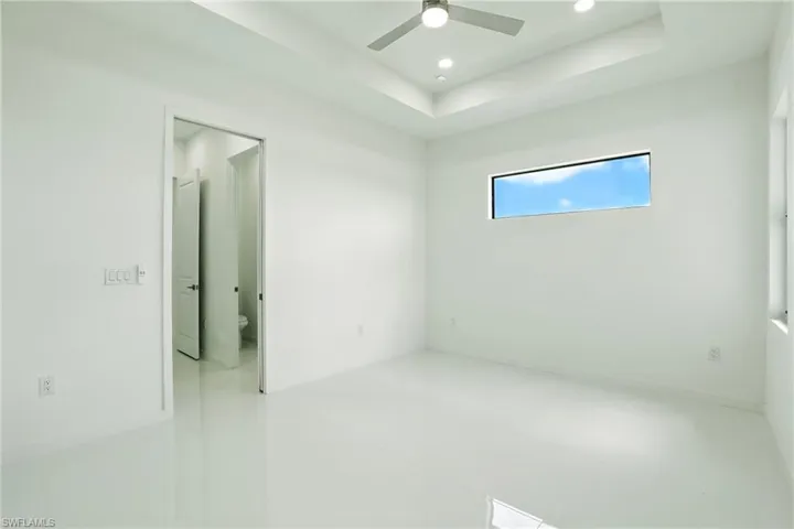 Unfurnished room with a tray ceiling, recessed lighting, and a ceiling fan