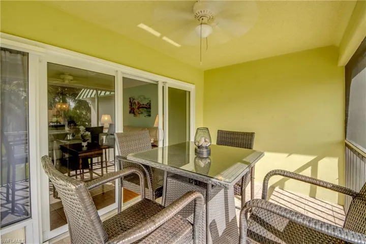 Sunroom / solarium with ceiling fan and outdoor dining area