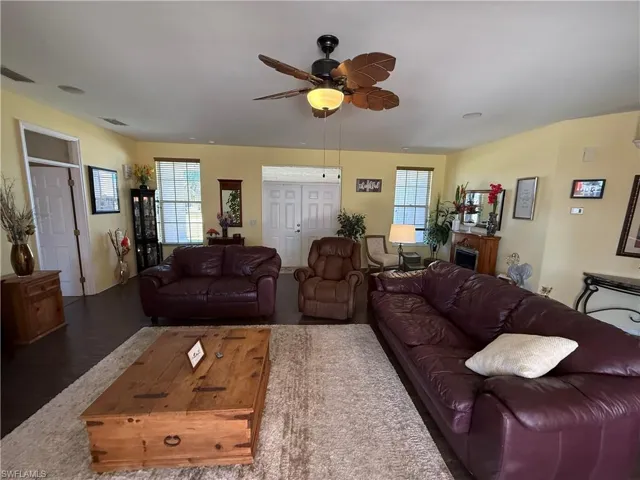 Living room featuring plenty of natural light, a ceiling fan, and wood finished floors