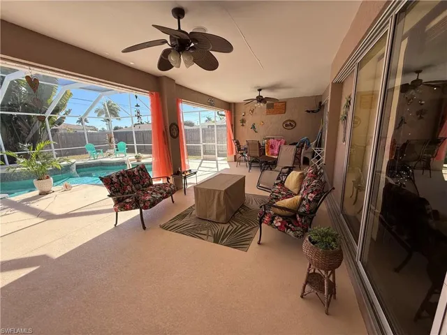 View of patio / terrace featuring a sunroom, a lanai, an outdoor pool, a ceiling fan, and outdoor seating
