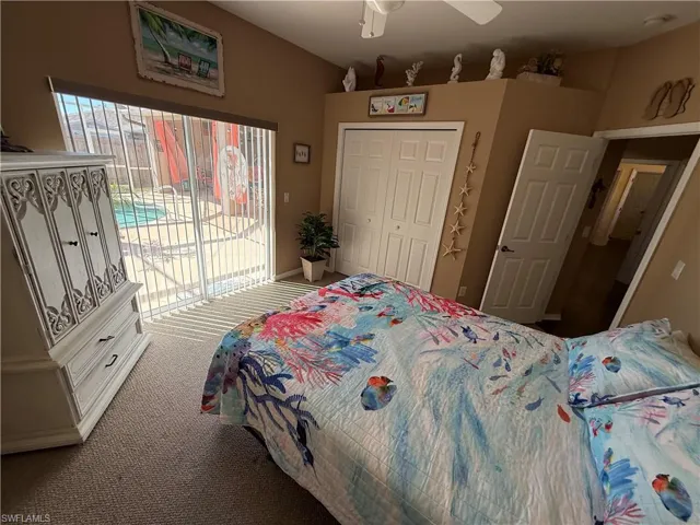 Bedroom with access to outside, carpet flooring, a closet, and ceiling fan