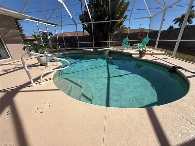 Integrated pool / spa featuring a patio area, glass enclosure, a fenced backyard, and a sunroom
