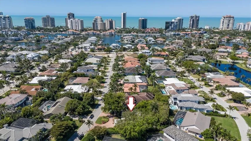 Birds eye view of property with a water view and a view of city
