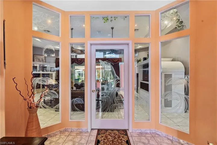 Entry foyer with etched  glass door and panels