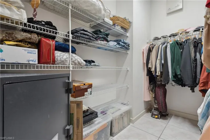 Owners' suite with walk-in closet and 1 other mirrored closet
