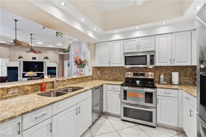 Kitchen with granite counters and white cabinets