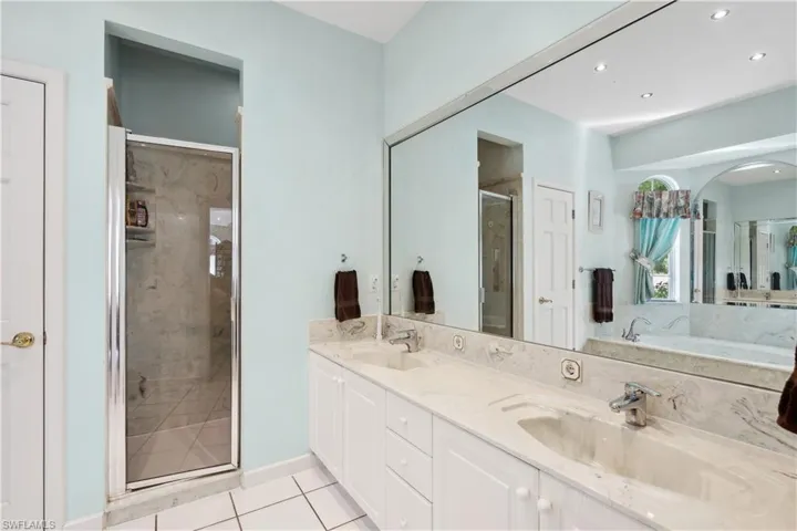 Owners' bath with double vanities and large walk-in shower