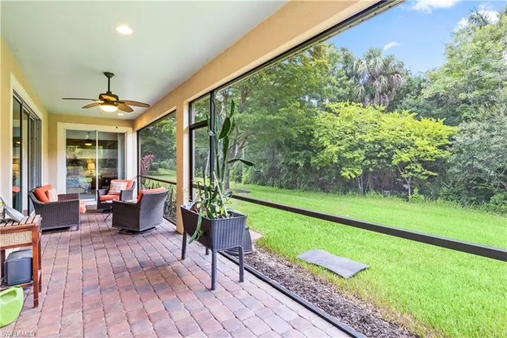 Unfurnished sunroom featuring ceiling fan