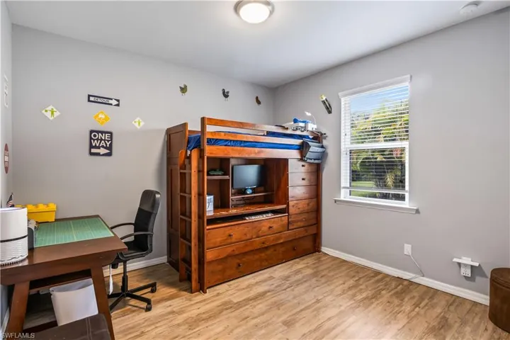 Bedroom with light hardwood / wood-style flooring