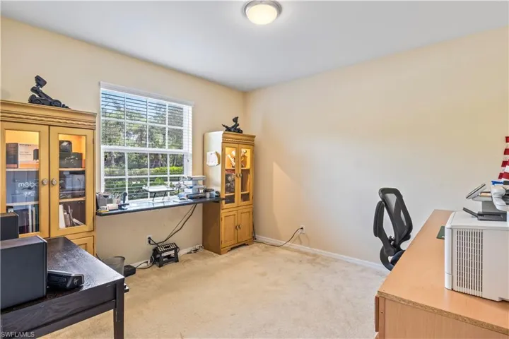 Carpeted office with french doors