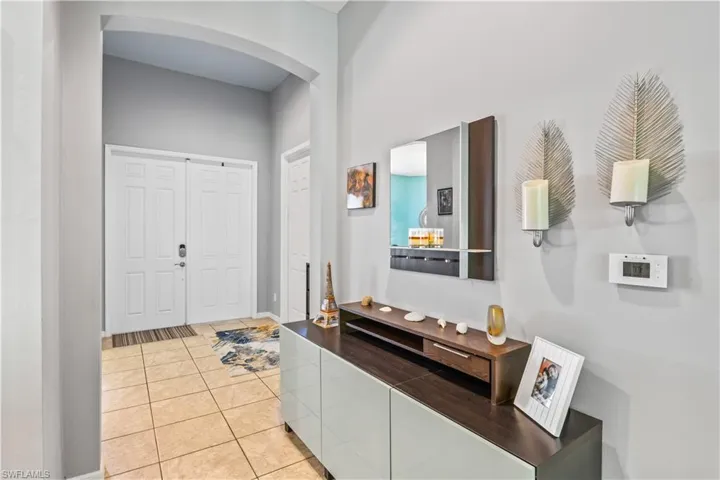 Foyer entrance featuring light tile patterned flooring
