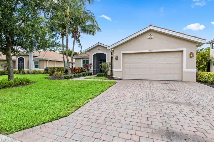 Single story home featuring a garage and a front yard