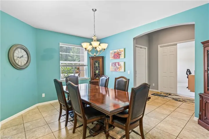 Tiled dining space with a chandelier