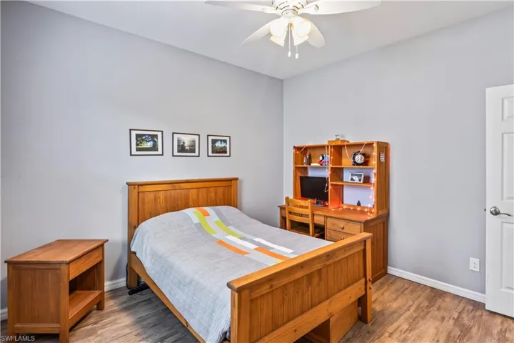 Bedroom with hardwood / wood-style flooring and ceiling fan