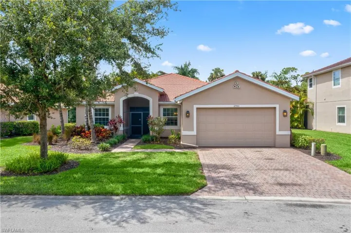 View of front of property with a garage and a front yard