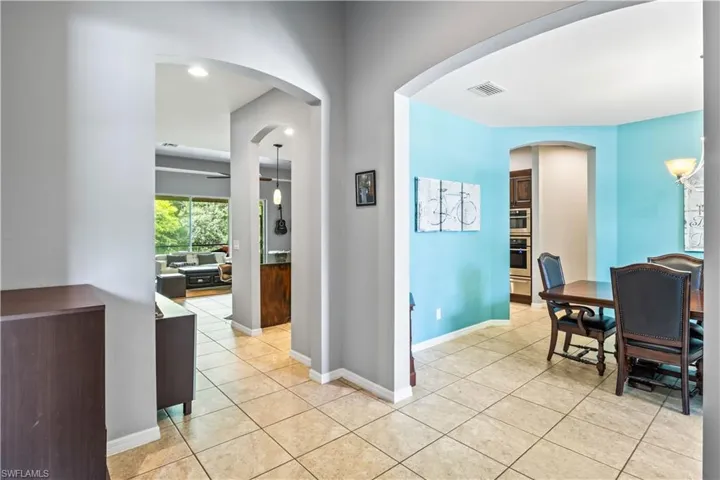 Hall featuring light tile patterned flooring