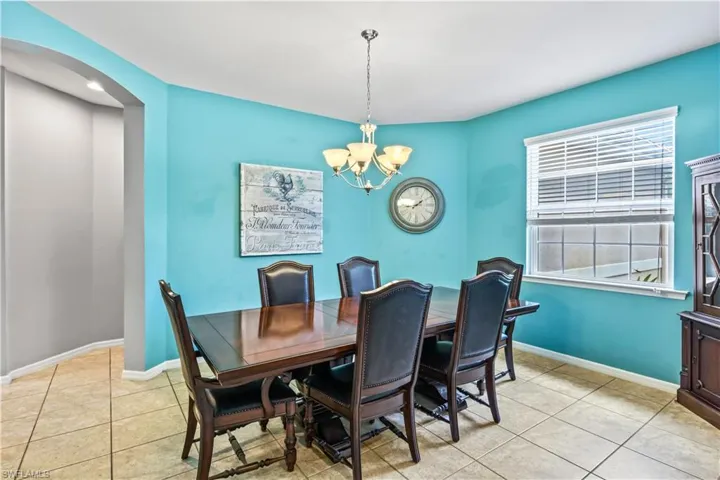 Dining room featuring an inviting chandelier and light tile patterned floors