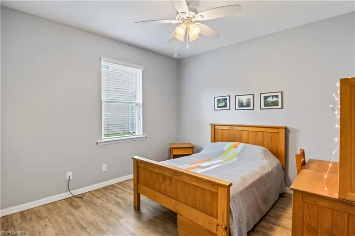 Bedroom featuring ceiling fan and light hardwood / wood-style flooring