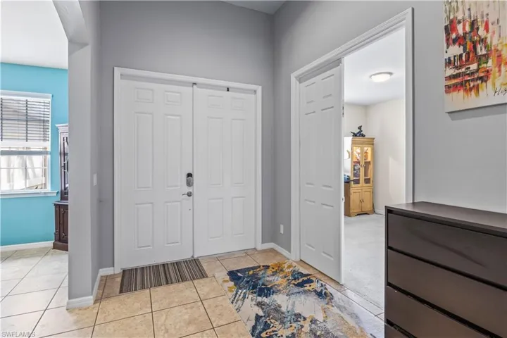 Foyer entrance with light tile patterned floors