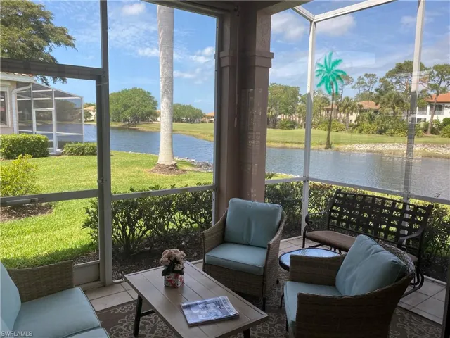 Sunroom featuring a water view