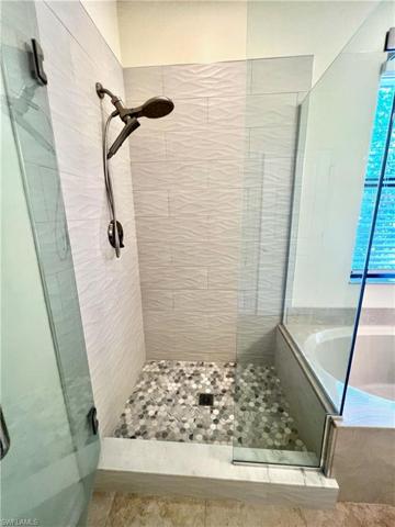 Newly updated shower- New Tile throughout & Glass Door/Enclosure