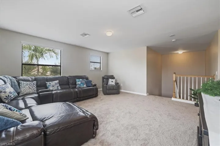 Carpeted living room featuring baseboards