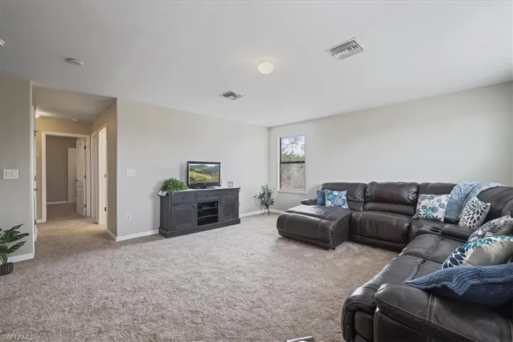 Carpeted living room featuring baseboards