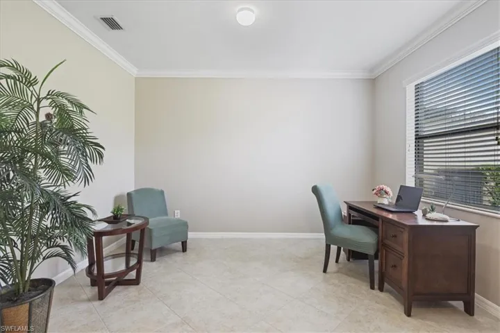 Home office featuring ornamental molding and light tile patterned flooring