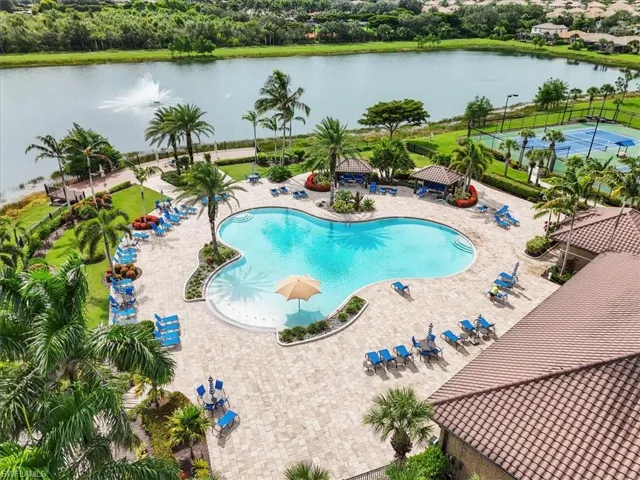 Community pool featuring a water view, a gazebo, and a patio
