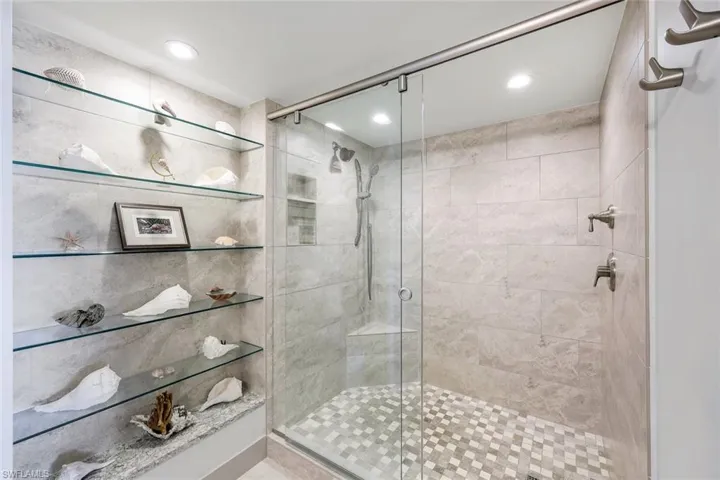 Bathroom featuring a shower with door