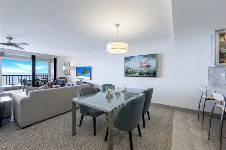 Dining space featuring ceiling fan and light tile patterned floors