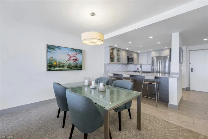 Carpeted dining space featuring sink