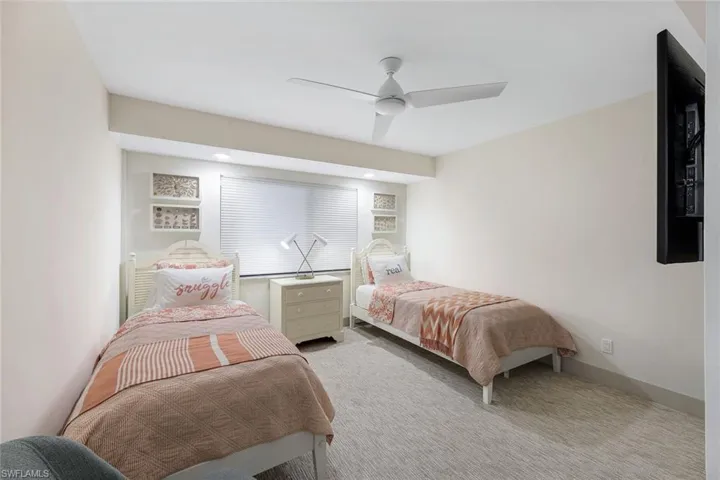 Carpeted bedroom featuring ceiling fan