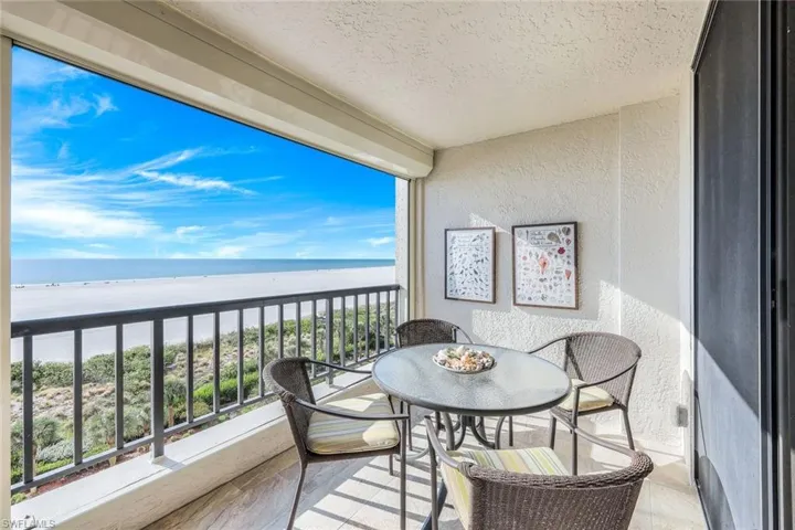 Balcony with a water view and a beach view