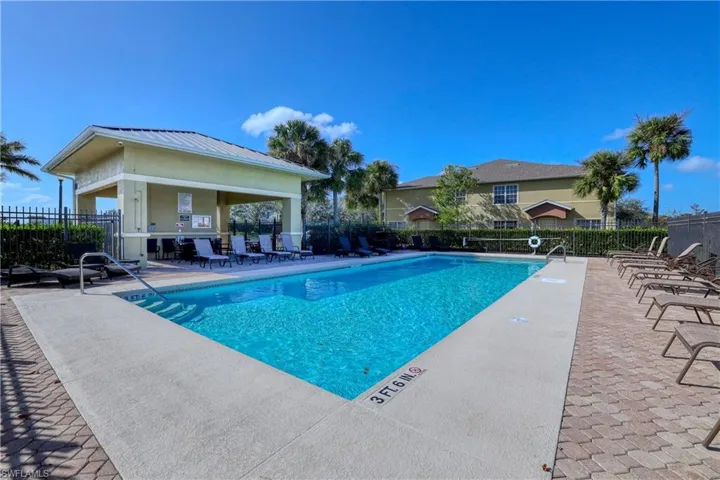 Community pool with fence, a patio area, and a gazebo