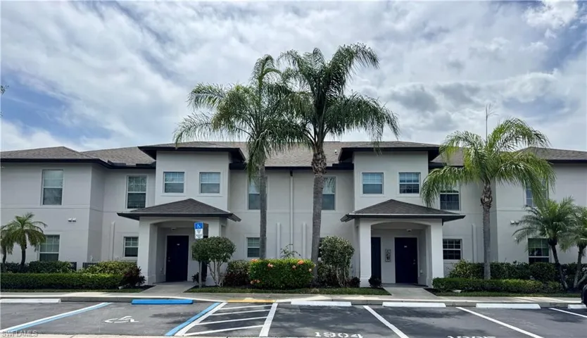 View of building exterior with uncovered parking