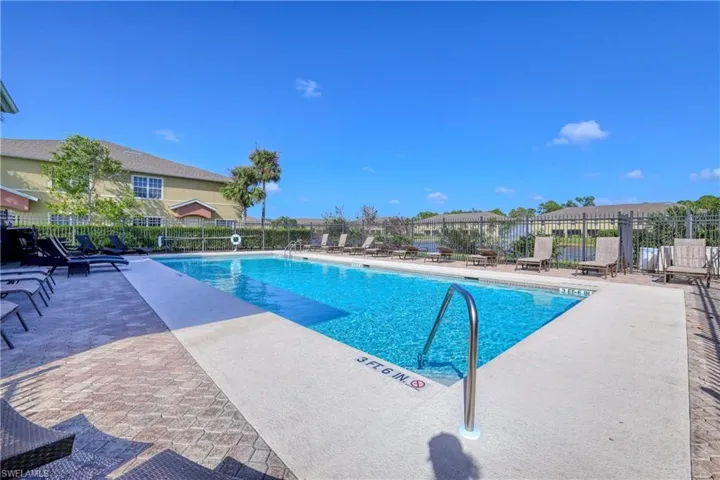 Community pool with fence and a patio